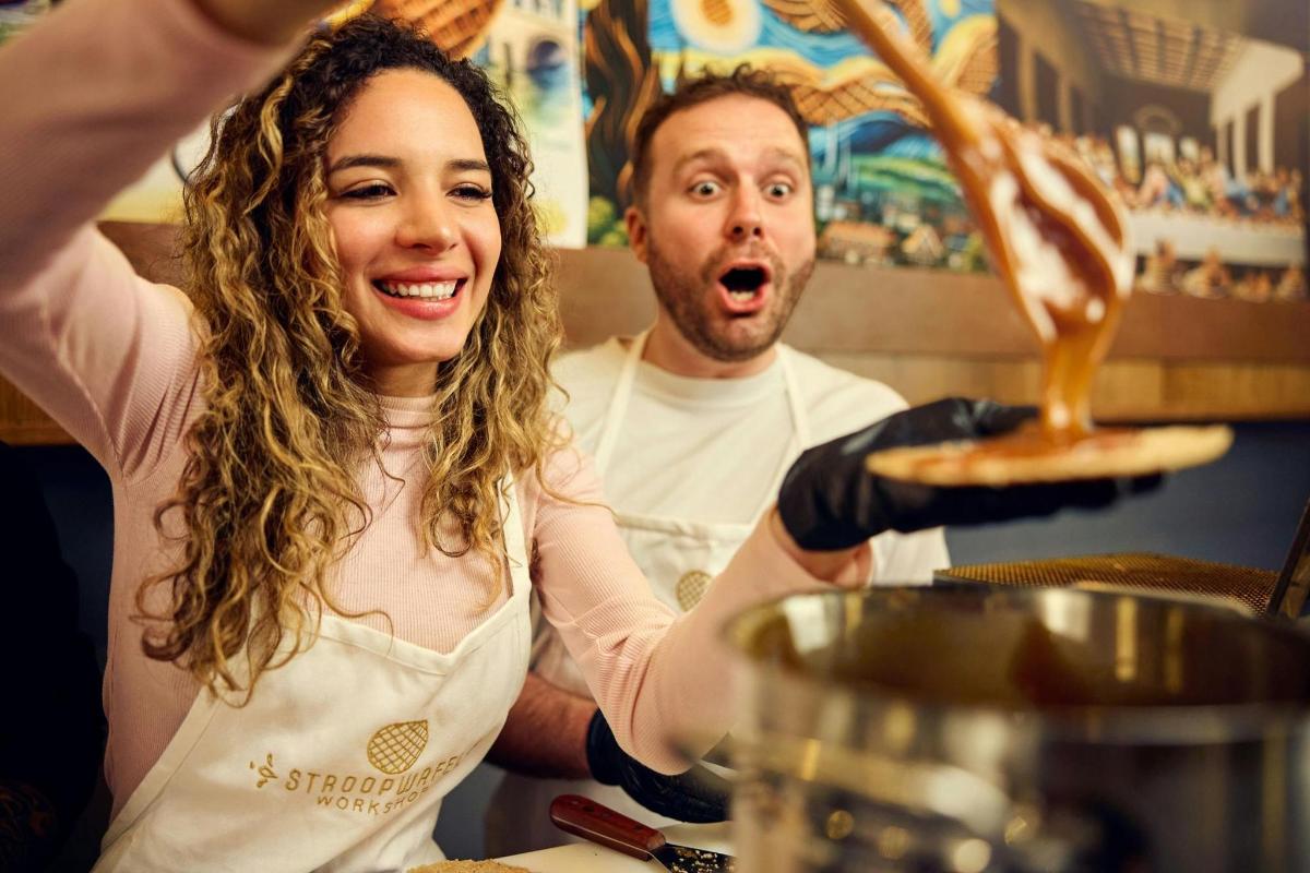 a man and a woman preparing food in a kitchen