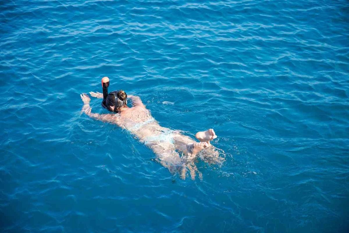 a man laying on his back in the water