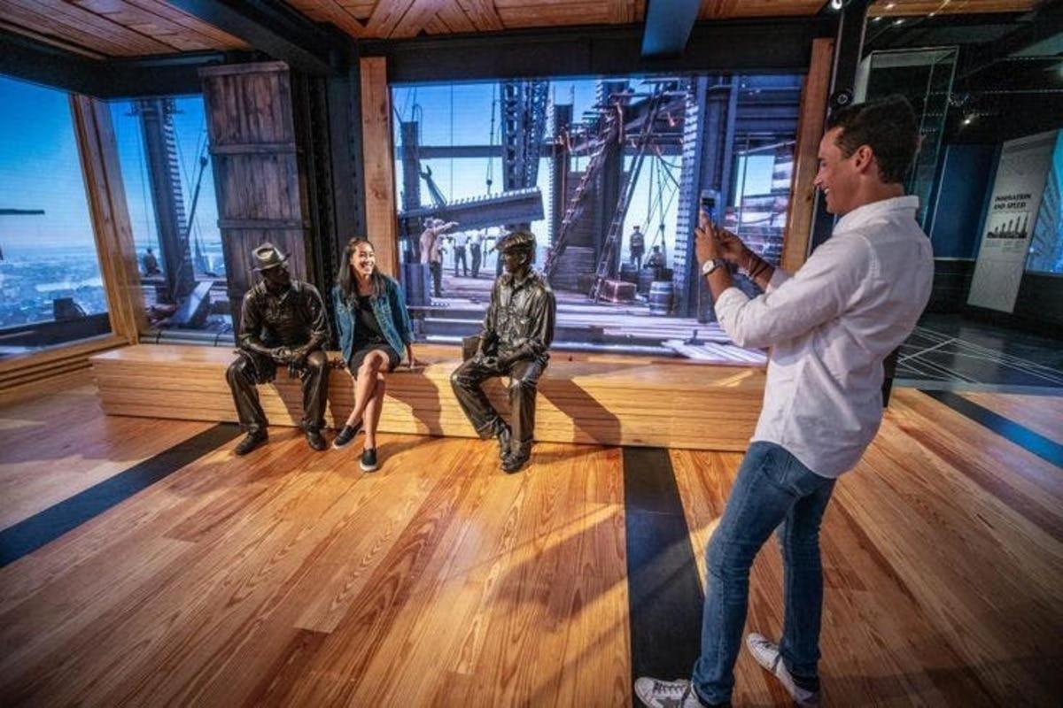a man taking a picture of a group of people on a stage