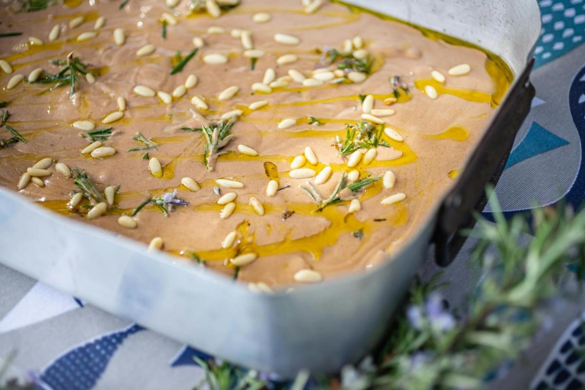 a dish of dip with seeds on top of it
