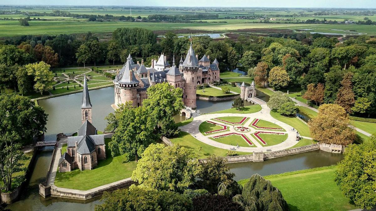 an aerial view of a castle in the middle of a river