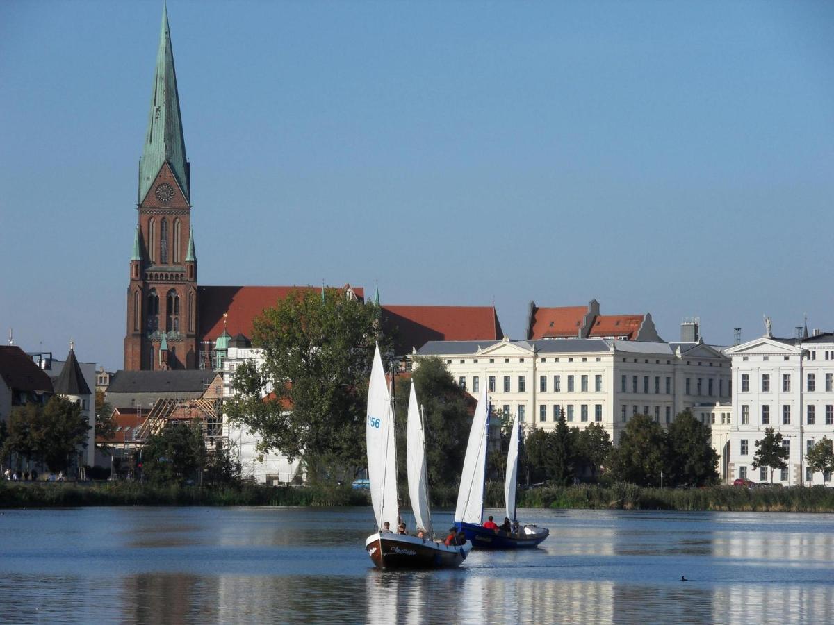 two sailboats on the water in front of a city