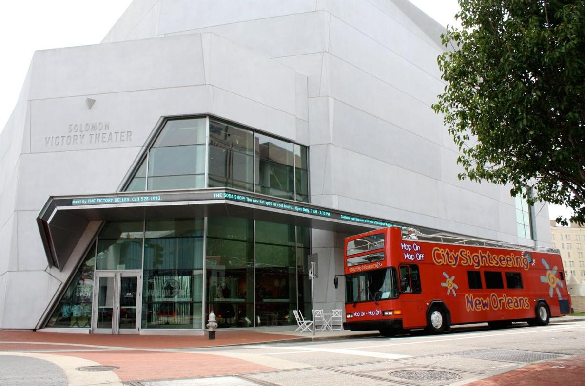 a red bus parked in front of a building