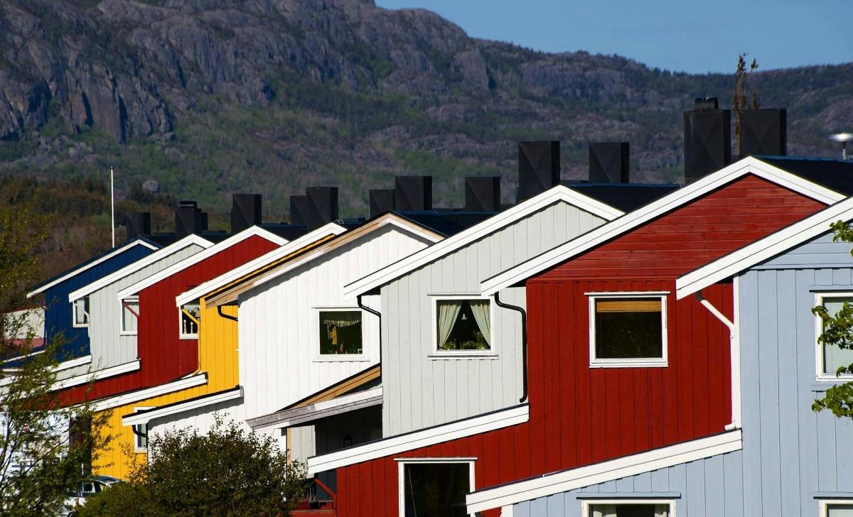 a row of houses with mountains in the background