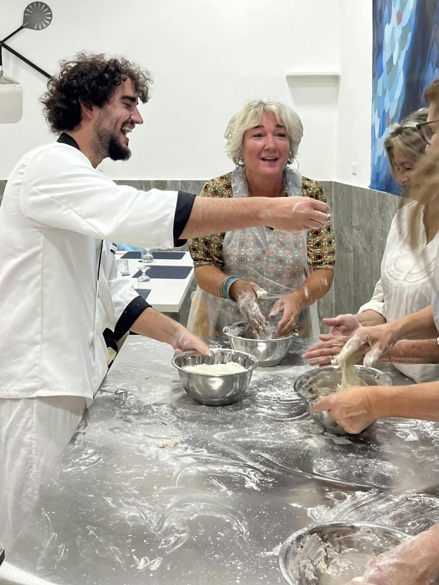 a group of people in a kitchen preparing food