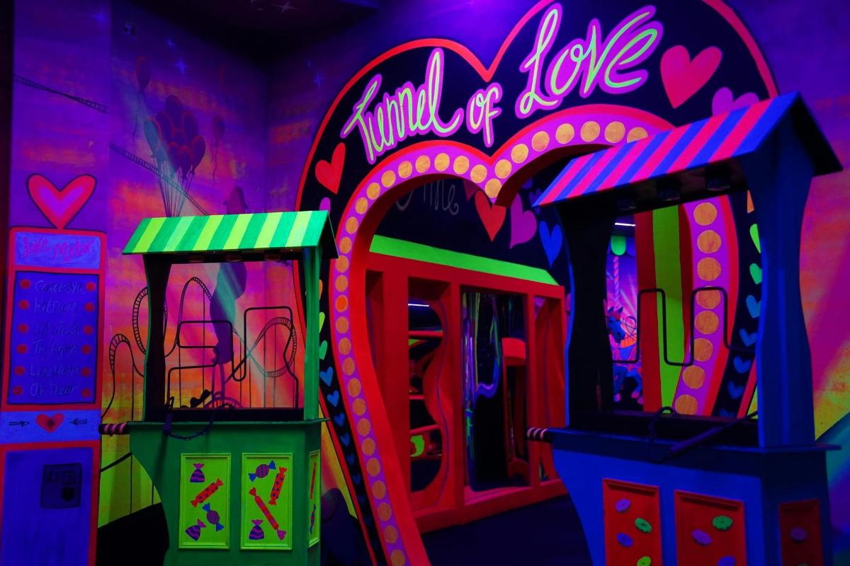 a neon sign that says milk of love in a room