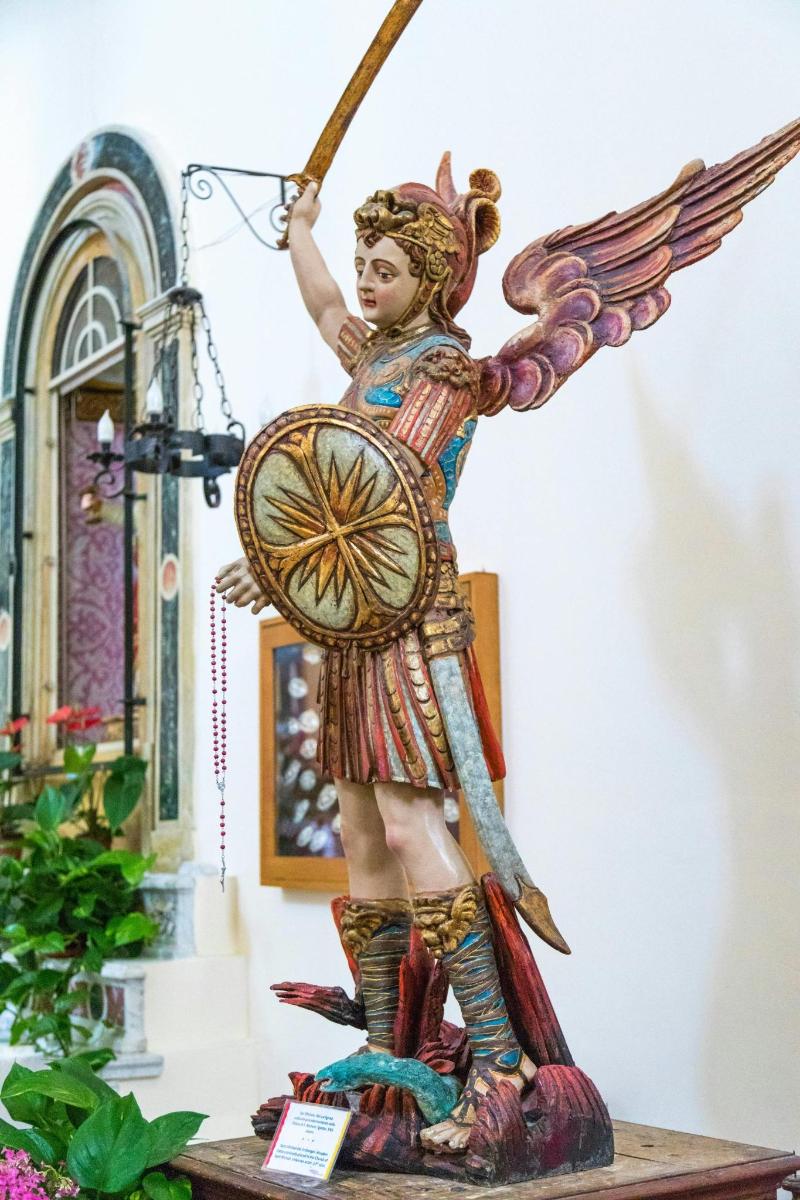 a statue of an angel holding a bow and arrow