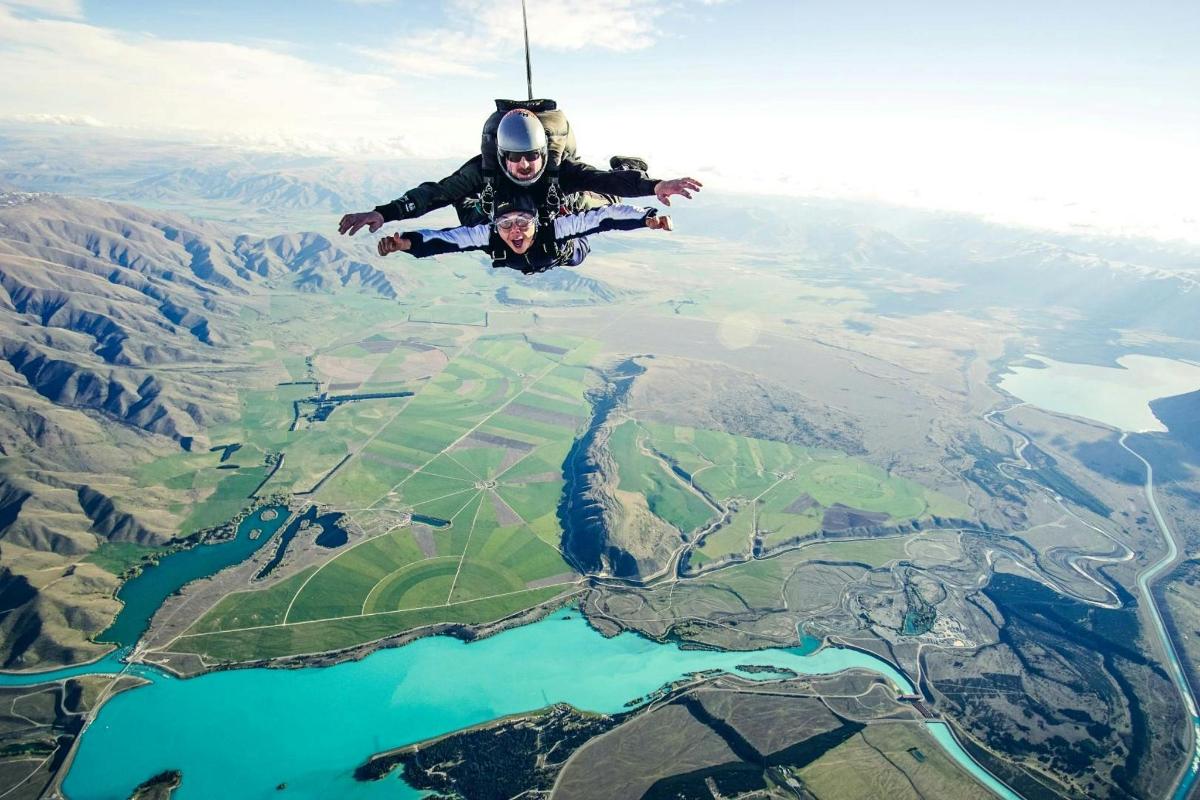 a man flying in the air over a lake