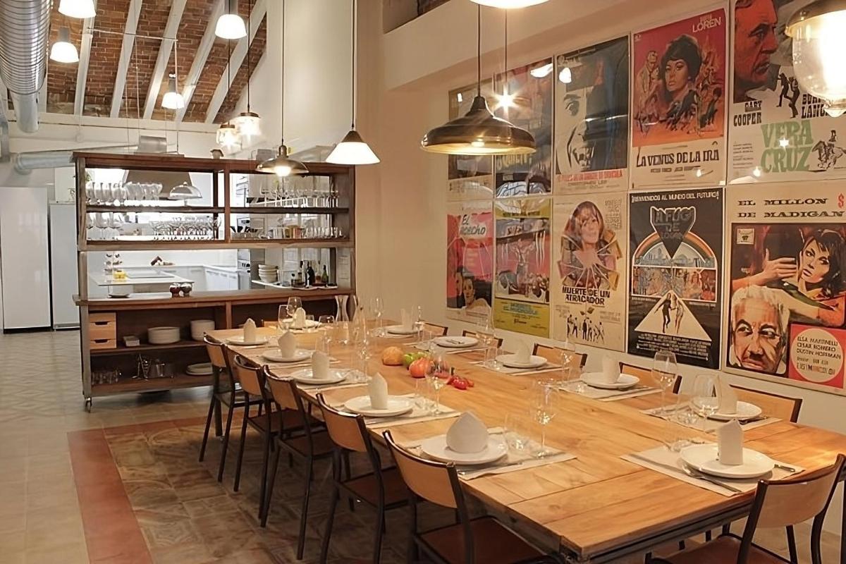 a dining room with a long table with chairs and posters