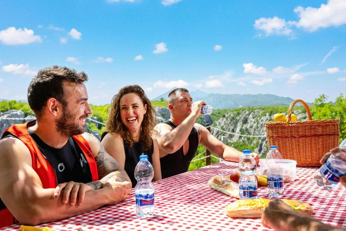a group of people sitting at a table with water bottles