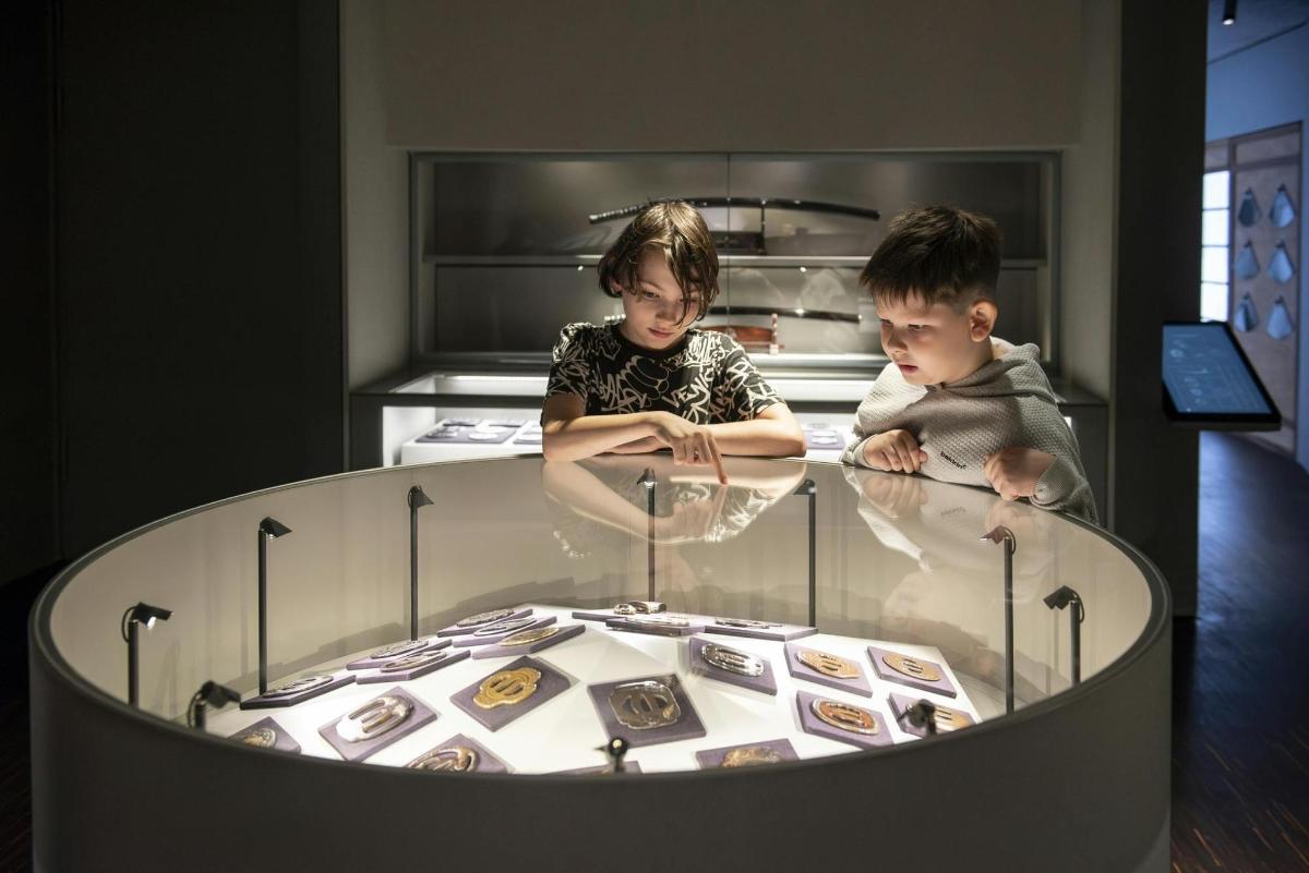 a boy and a girl sitting in front of a table
