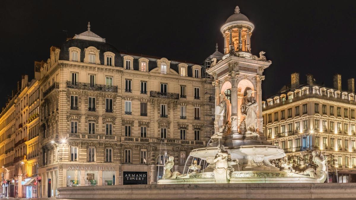 a large building with a fountain in front of a building