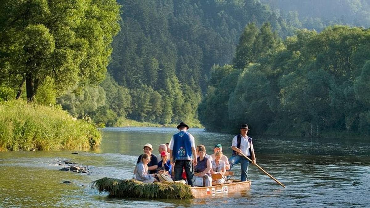 a group of people in a boat on a river