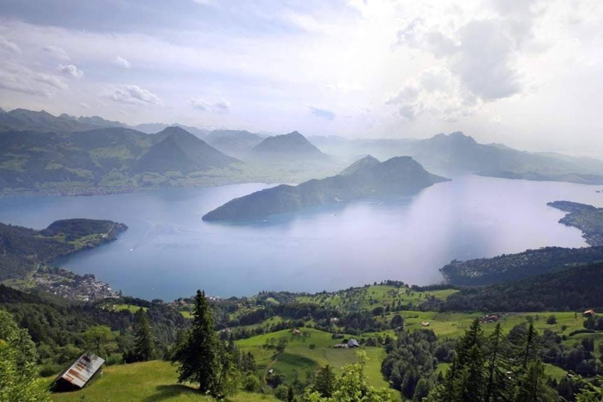 a view of a lake in a valley with mountains