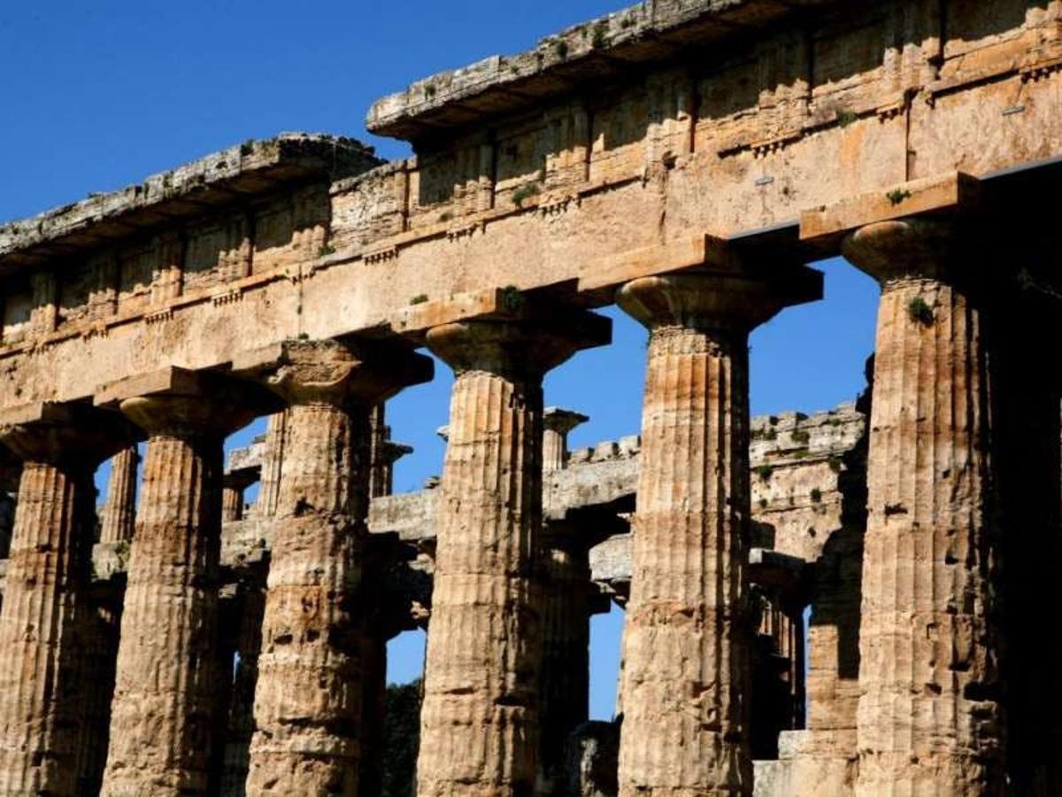 an ancient building with columns against a blue sky