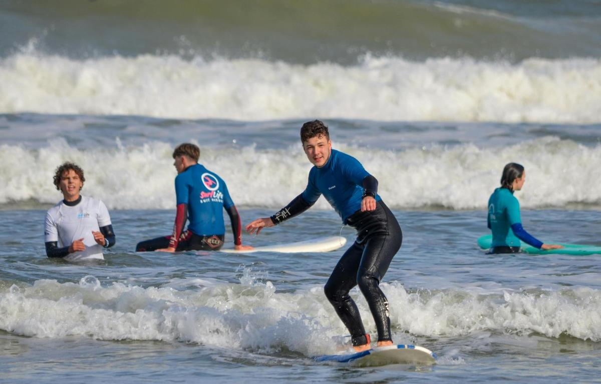 a man riding a wave on a surfboard in the ocean