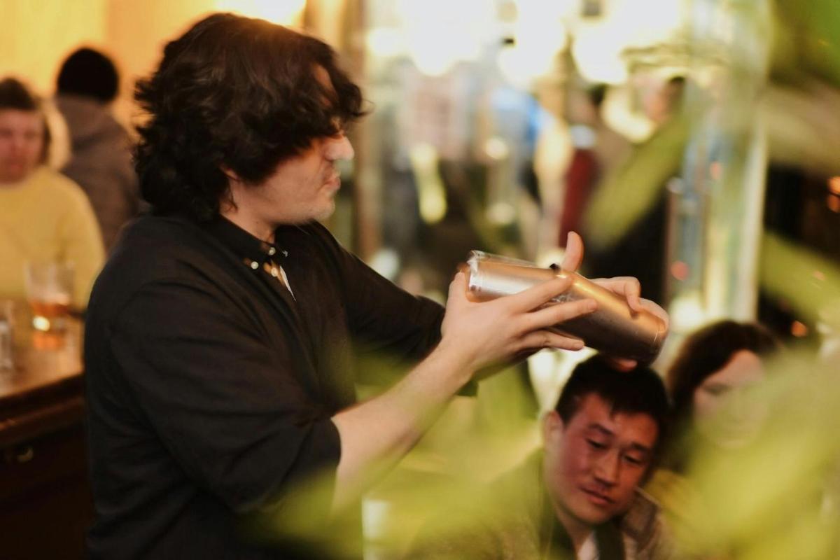 a man getting his hair cut in a barber shop