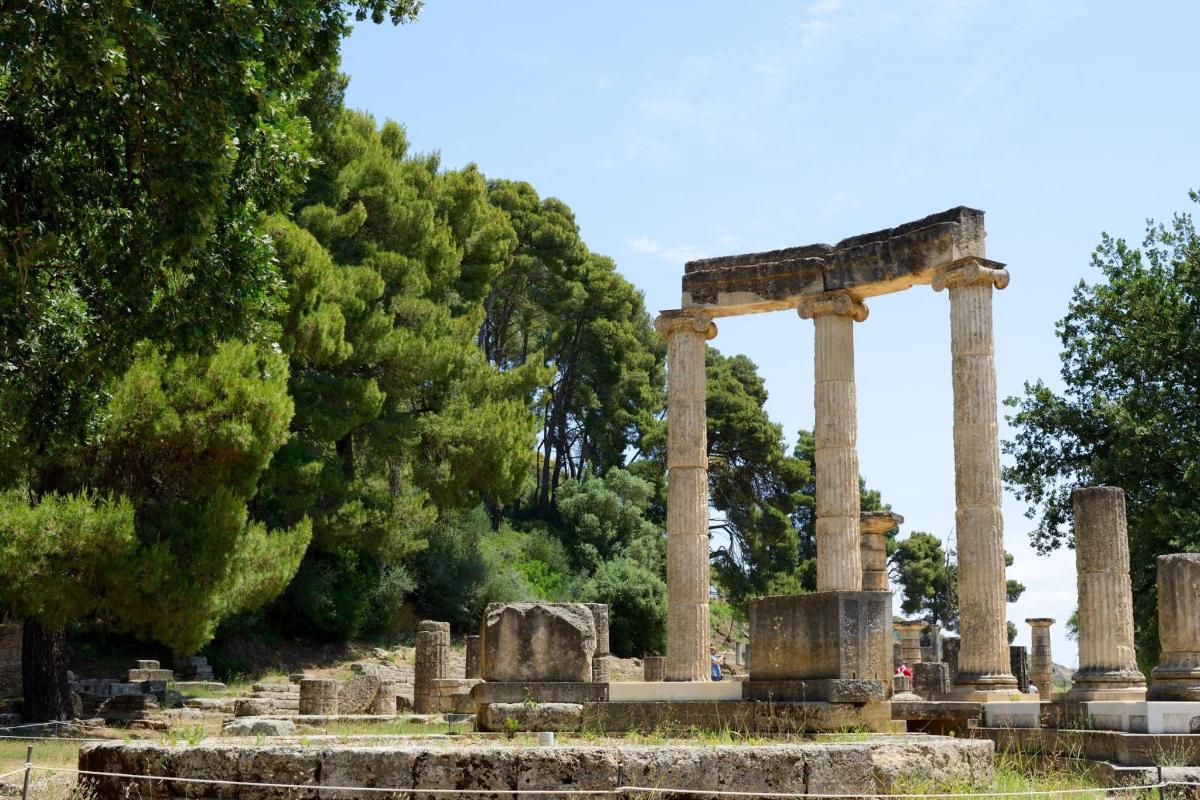 an ancient temple with trees in the background