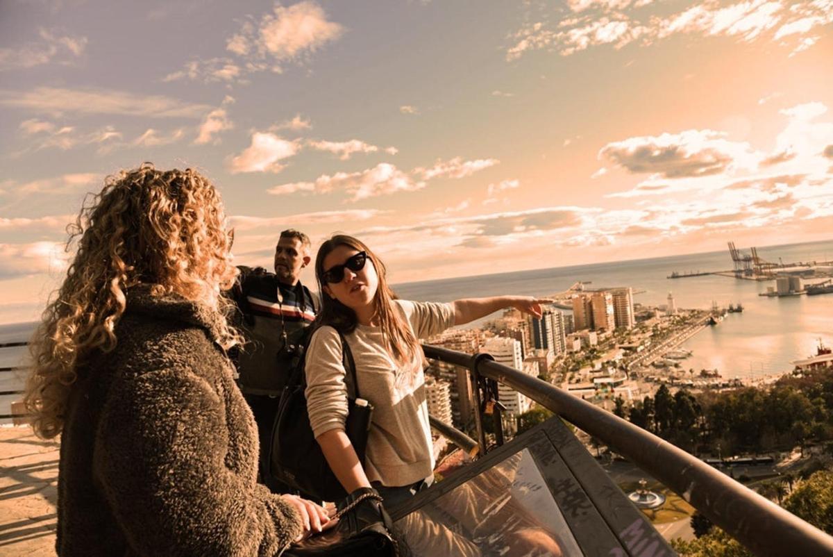 a group of people standing on top of a building