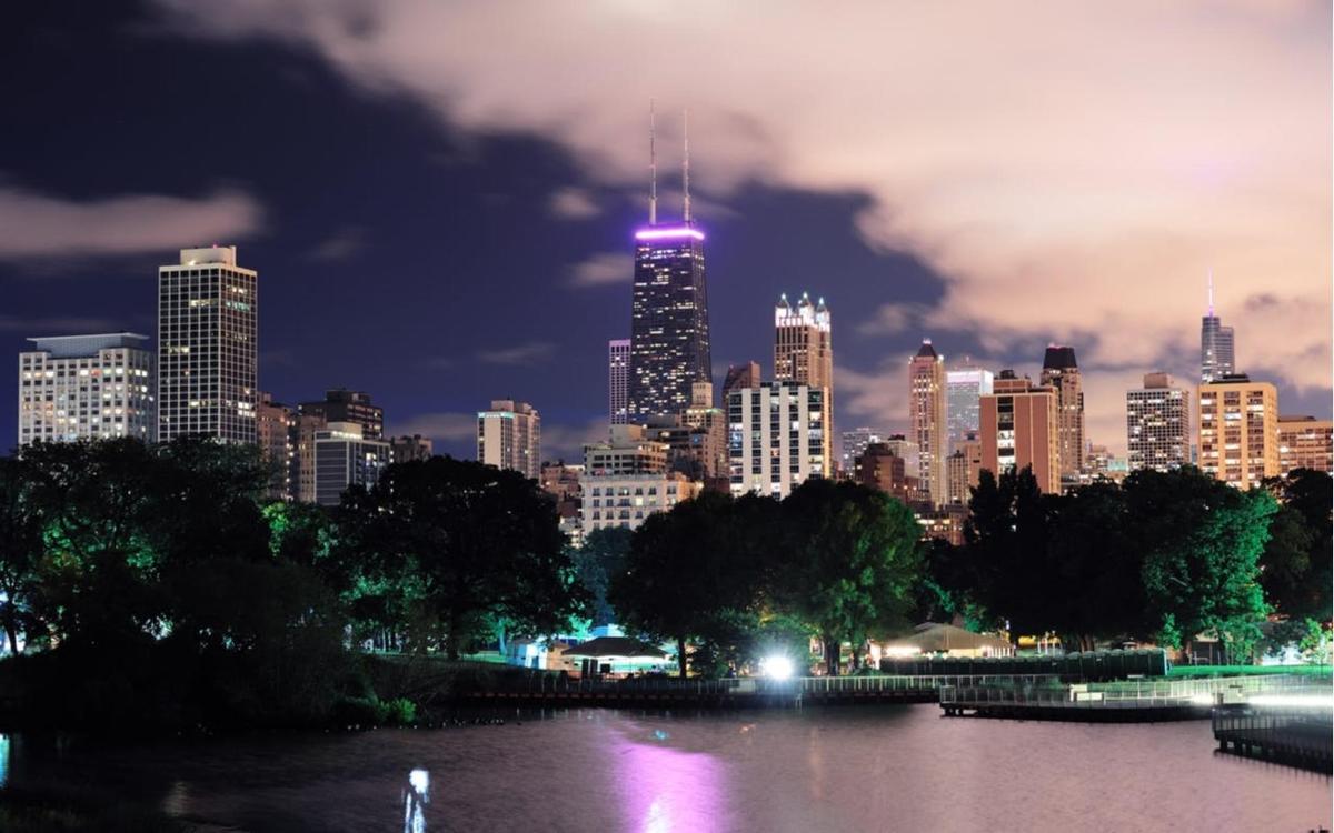 a city skyline at night with a lit up city