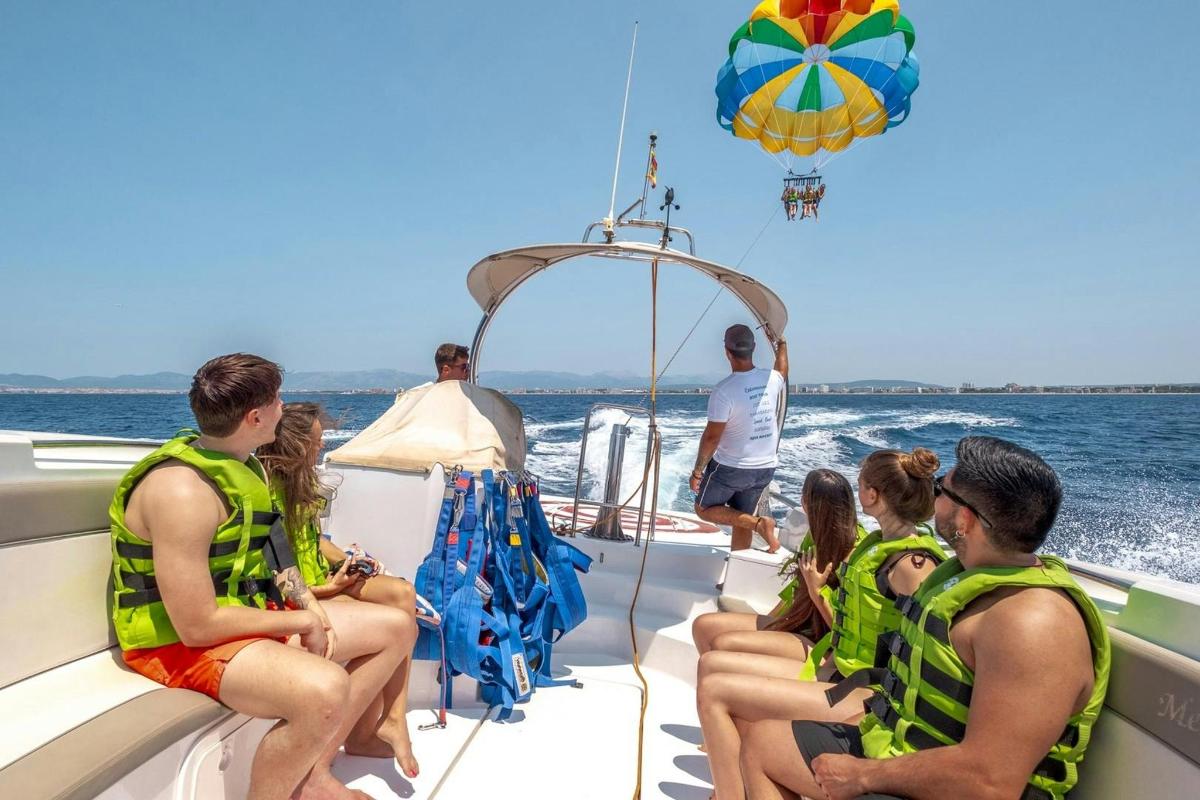 a group of people sitting on a boat on the water