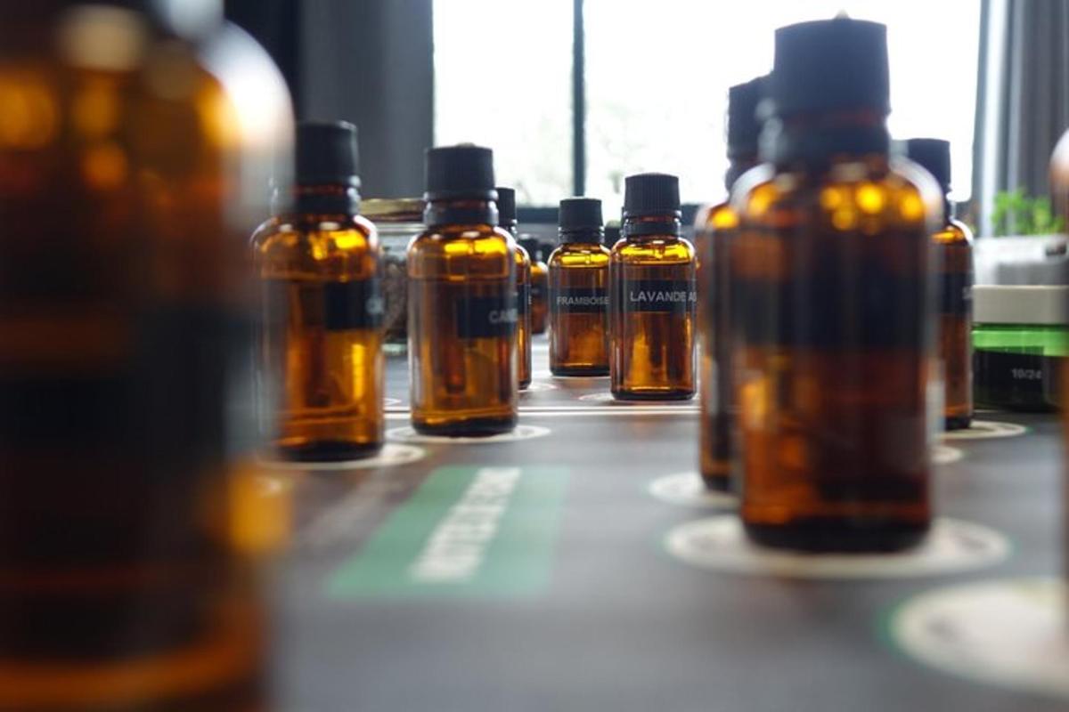 a row of bottles of oils sitting on a table