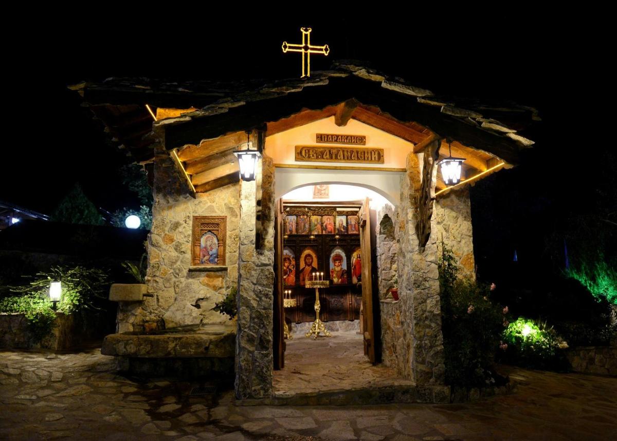 a small church with a cross at night