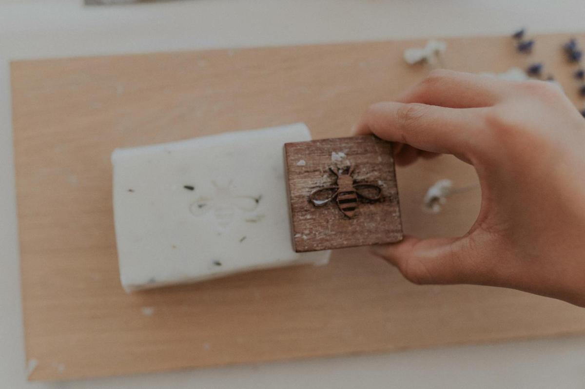 a person holding a box with a bee on it