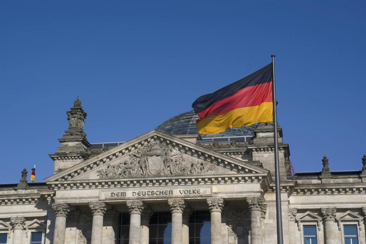 a flag flying in front of a building