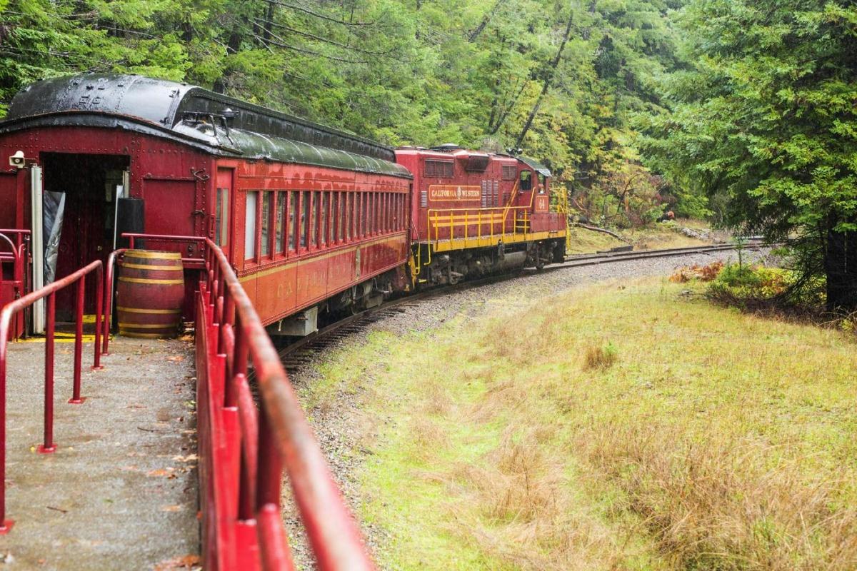 a red train is coming down the tracks