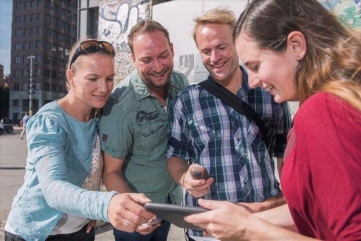 a group of people looking at a tablet computer
