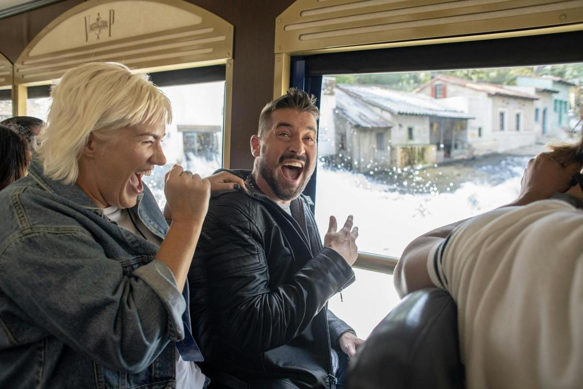 a man and a woman sitting on a train