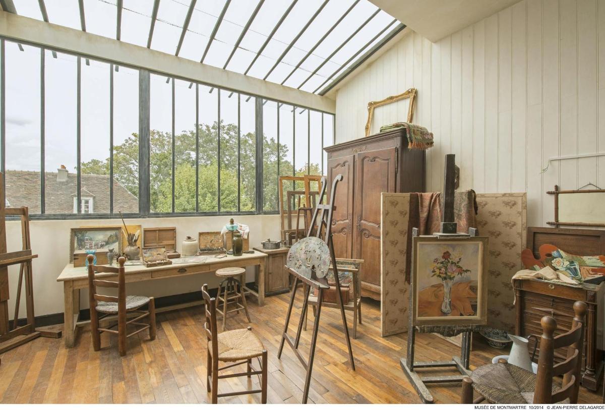 a room with a table and chairs and windows