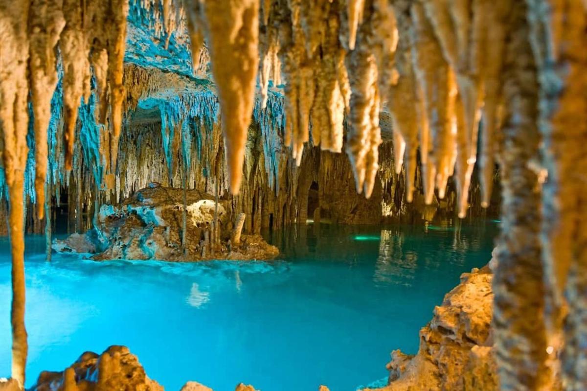 a cave filled with blue water and icicles