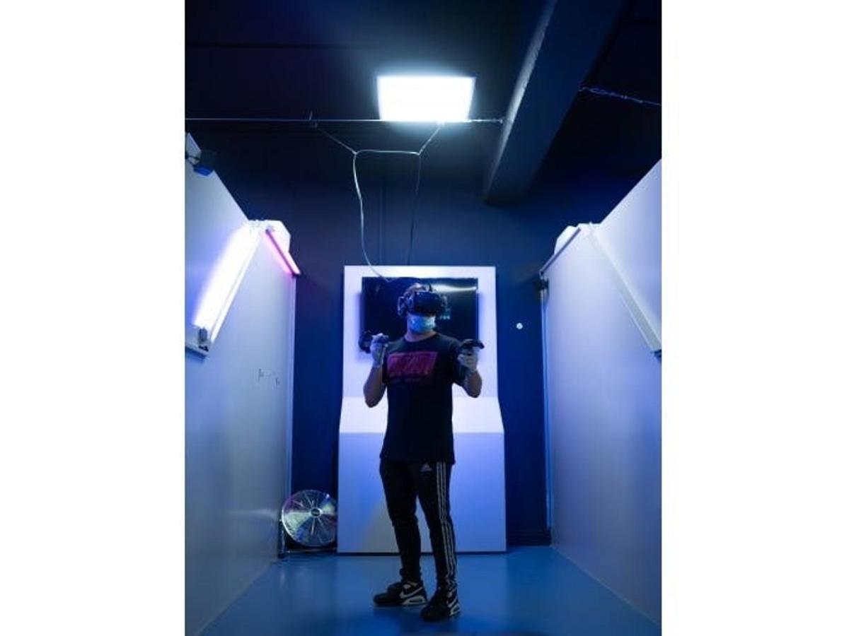 a man standing in a room with a blue wall