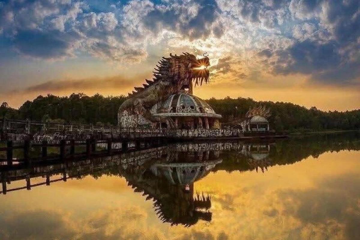 a dragon statue on a bridge over a body of water