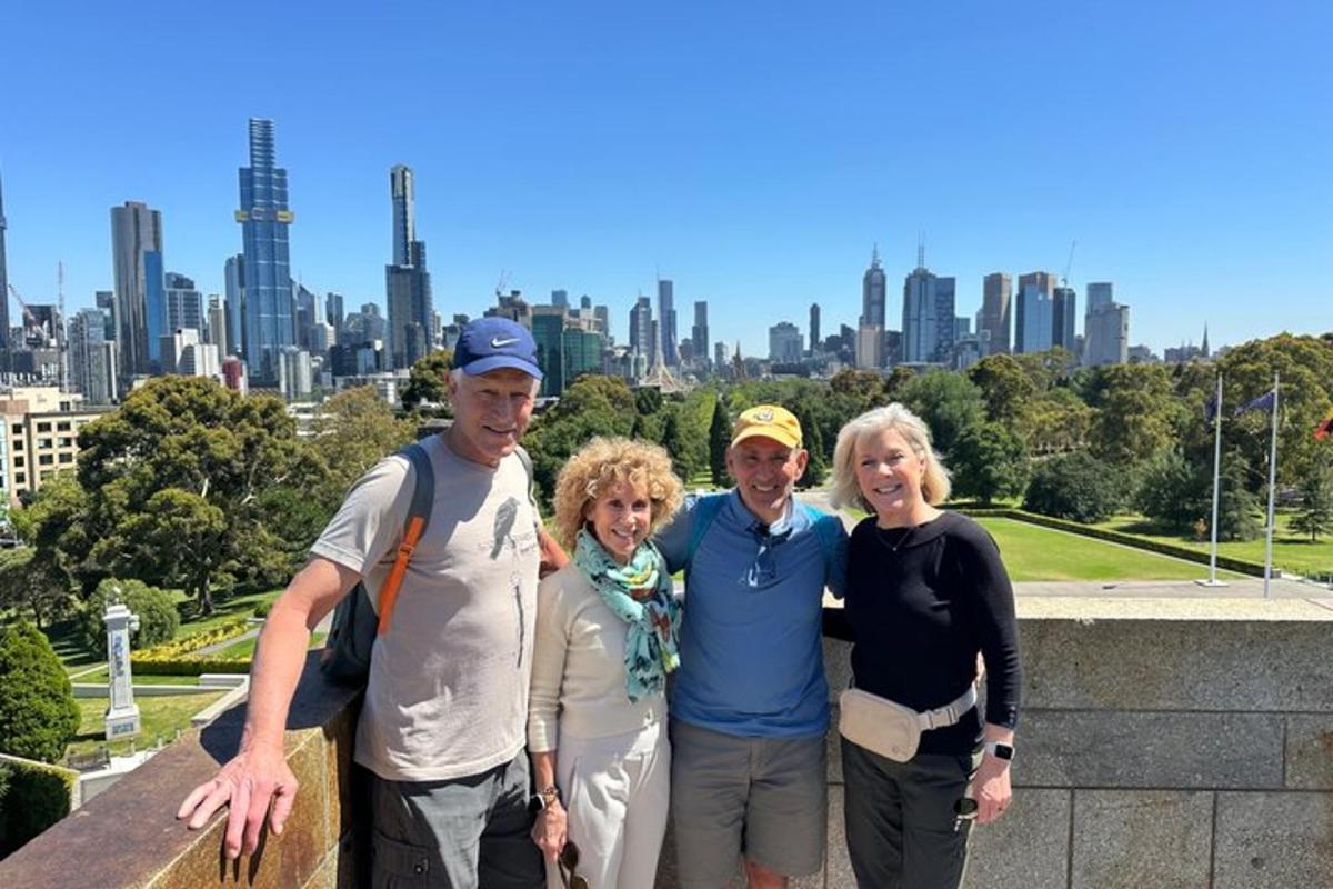 a group of people posing for a picture in front of a city