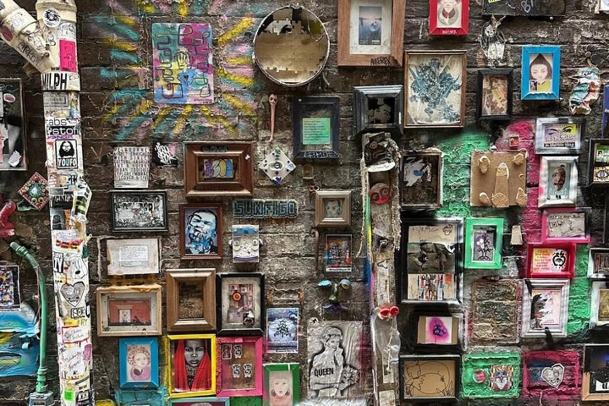 a wall full of pictures on a brick wall