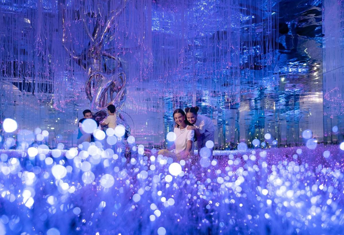 a group of people standing in a room with lights