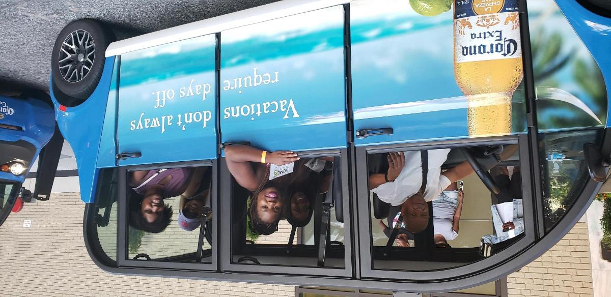 a blue double decker bus with people in the window