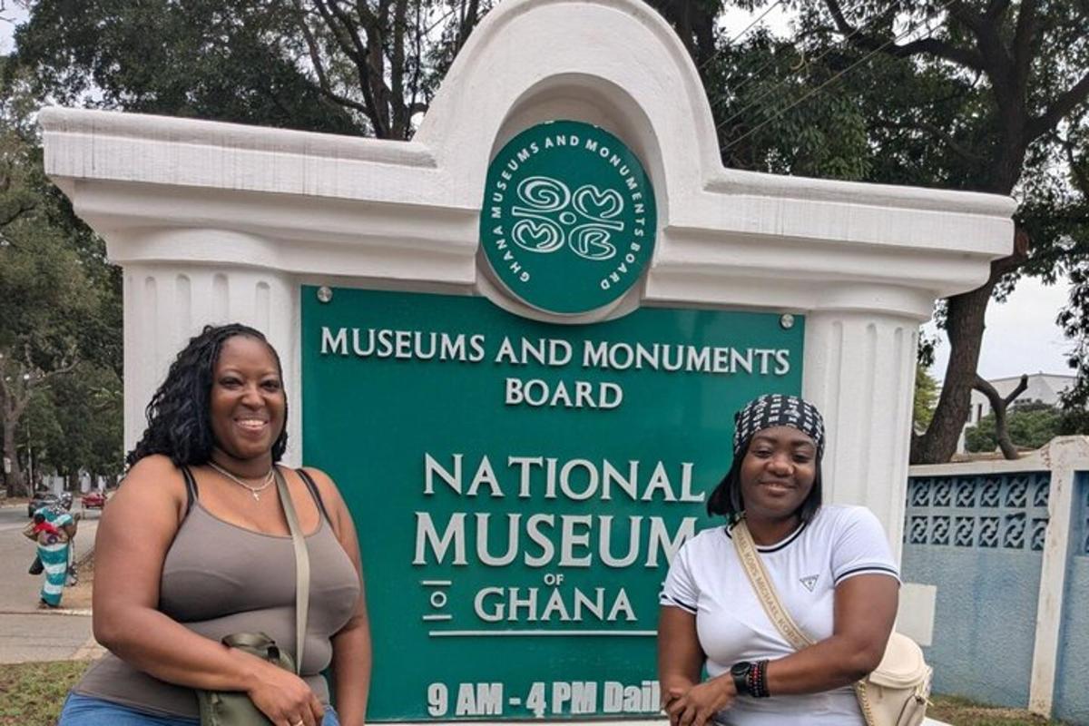 two women standing in front of a sign