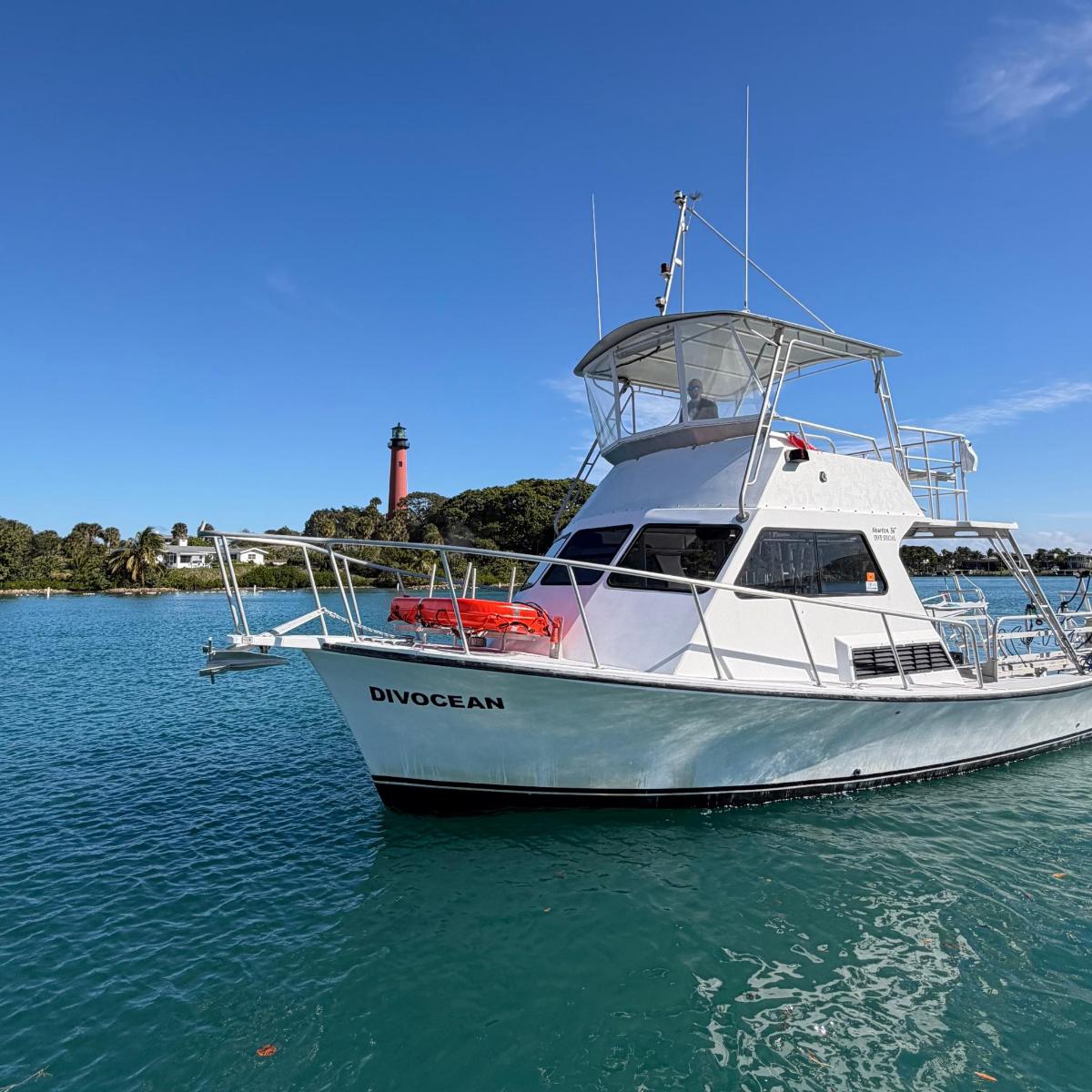 a white boat is sitting in the water