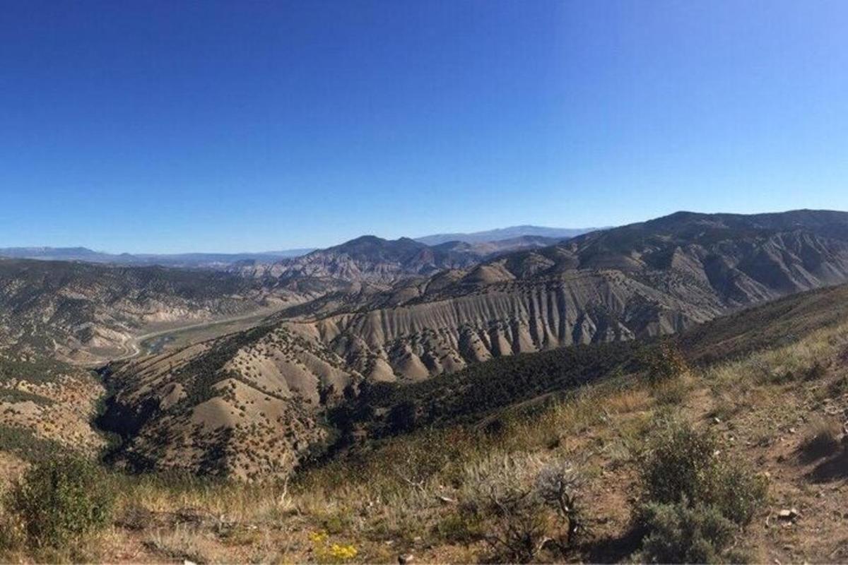a view of a canyon with mountains in the background