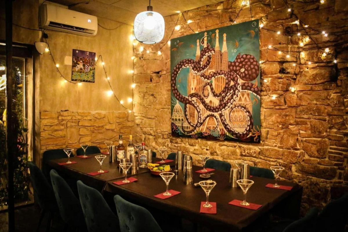 a table in a restaurant with a painting on the wall