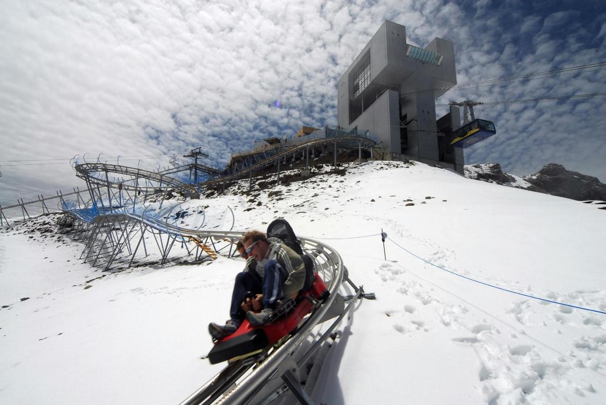a man riding on a ski lift in the snow