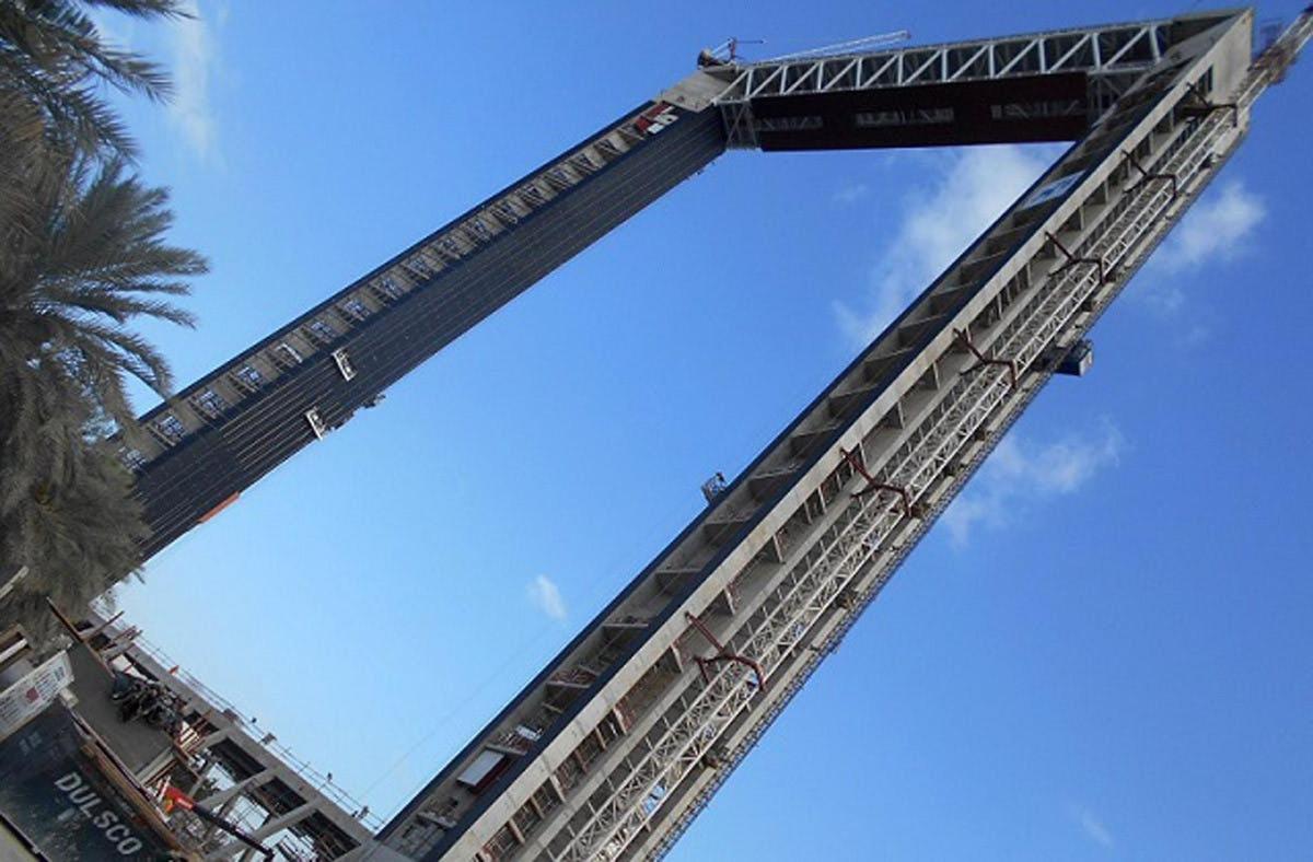 a tall crane with a blue sky in the background