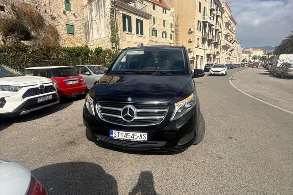 a black car parked on the side of a street
