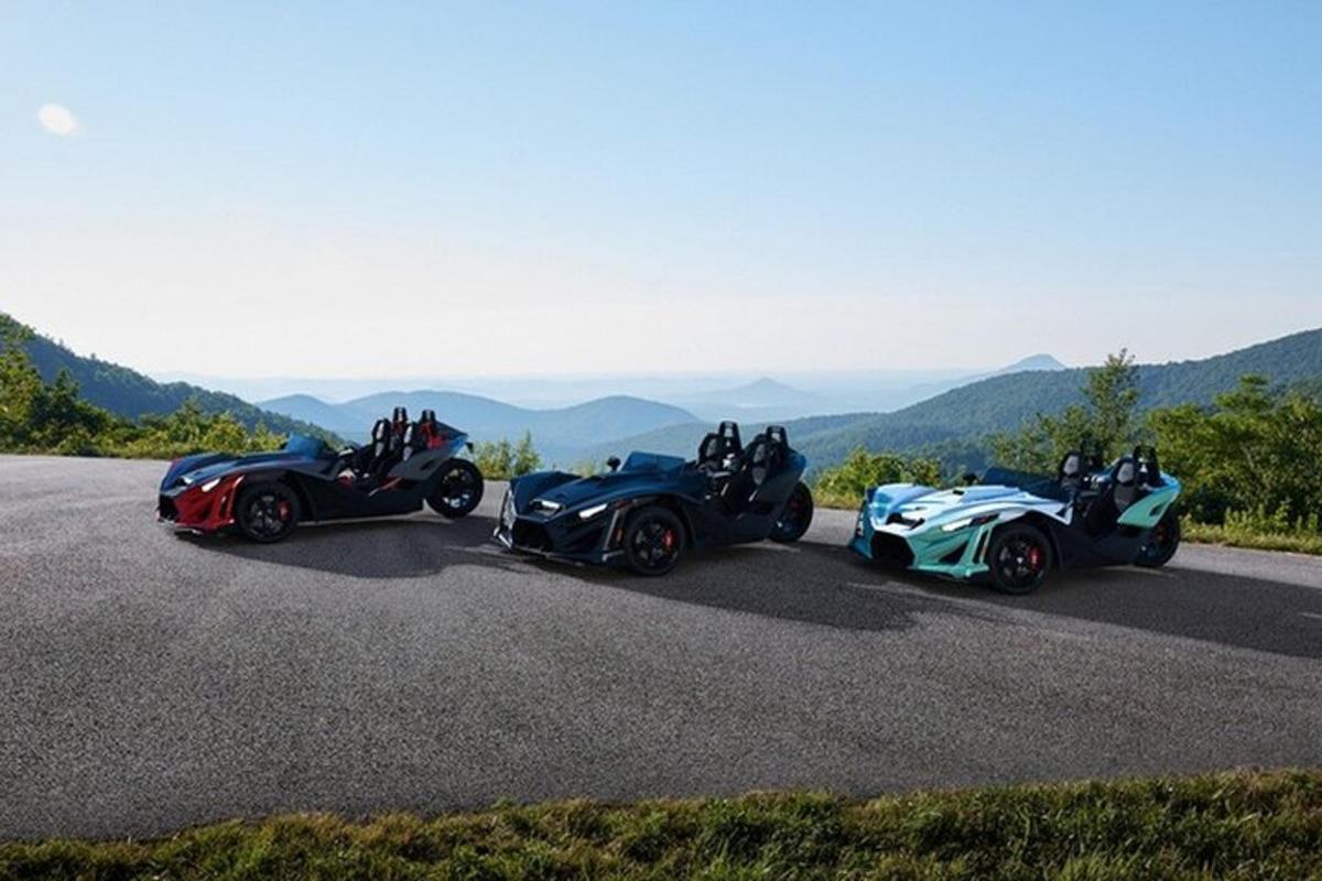 two atvs and twostriders driving down a road