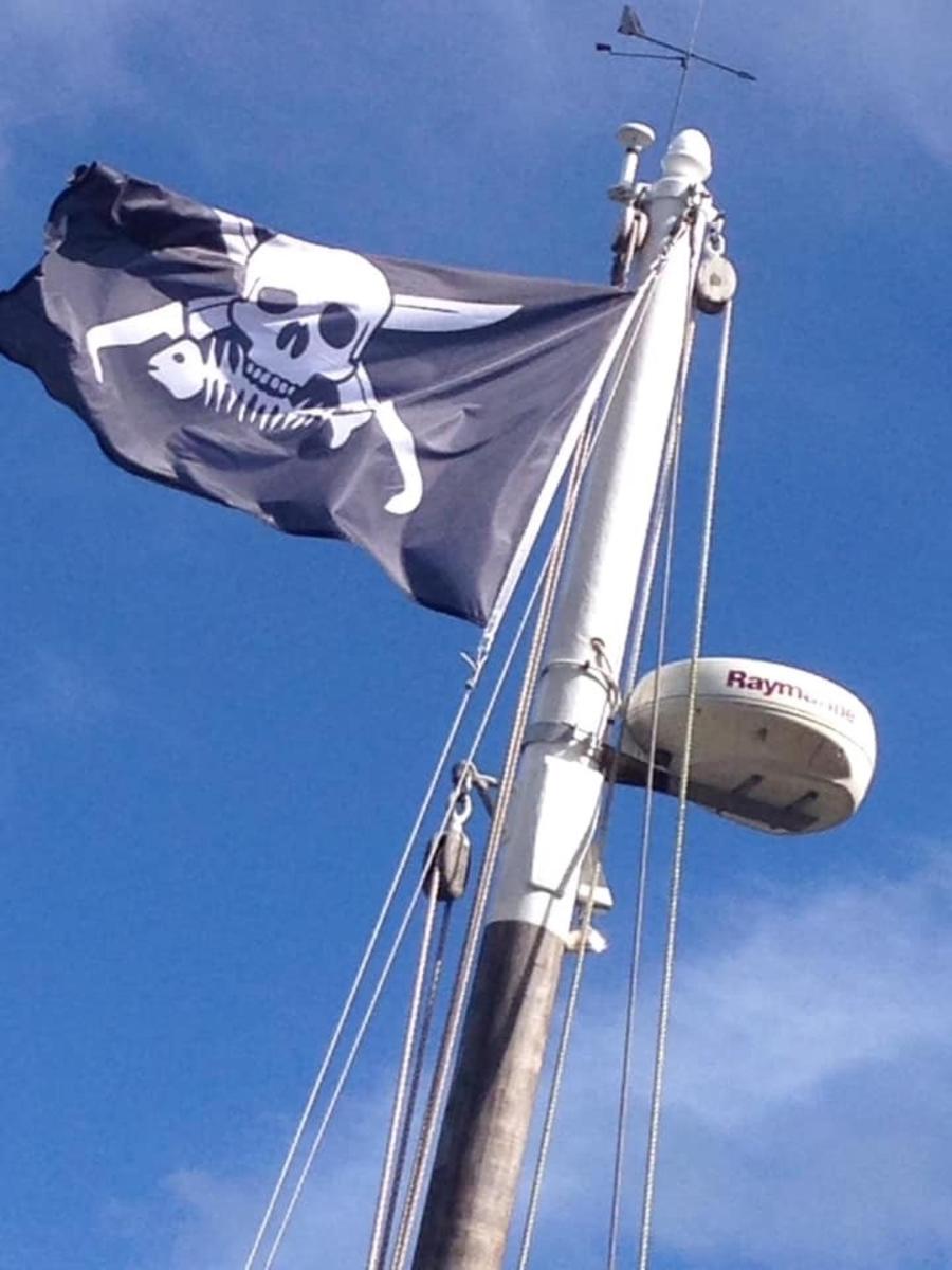 a flag on a ship with a skull on it