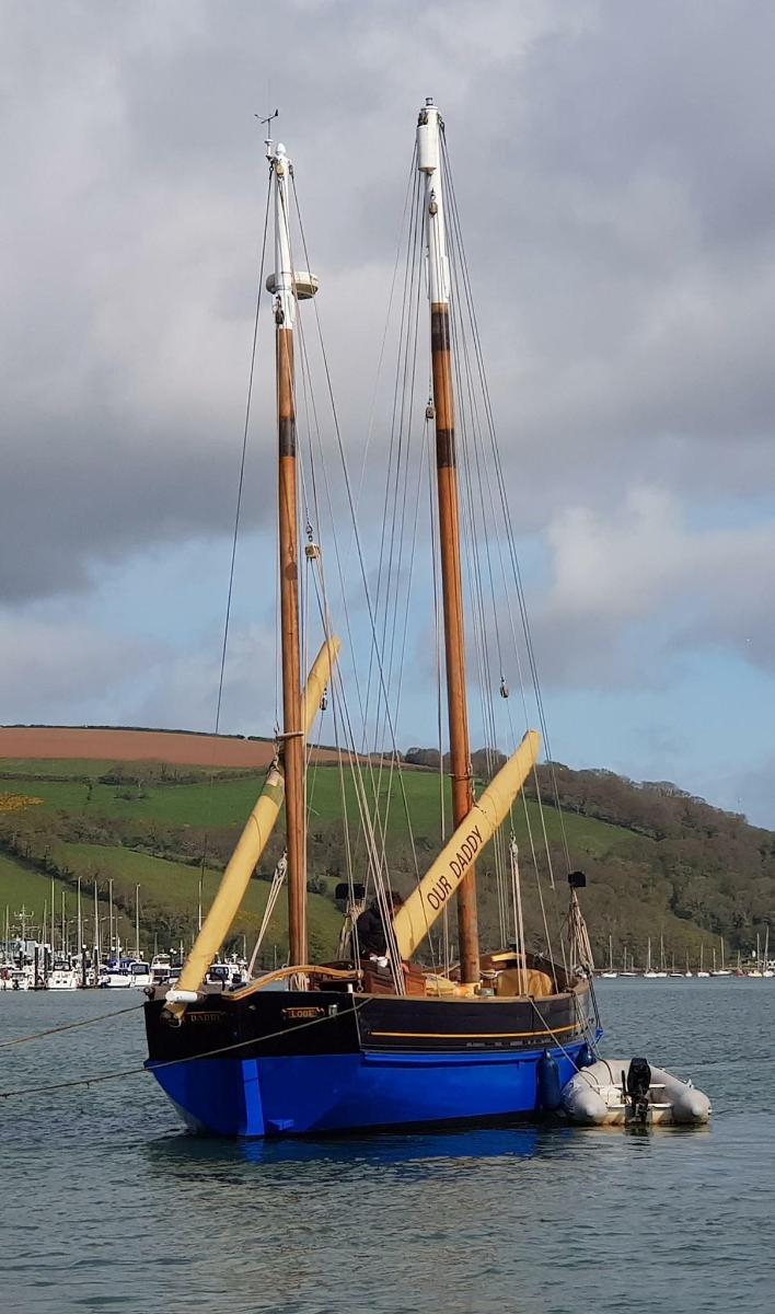 a sail boat is sitting in the water